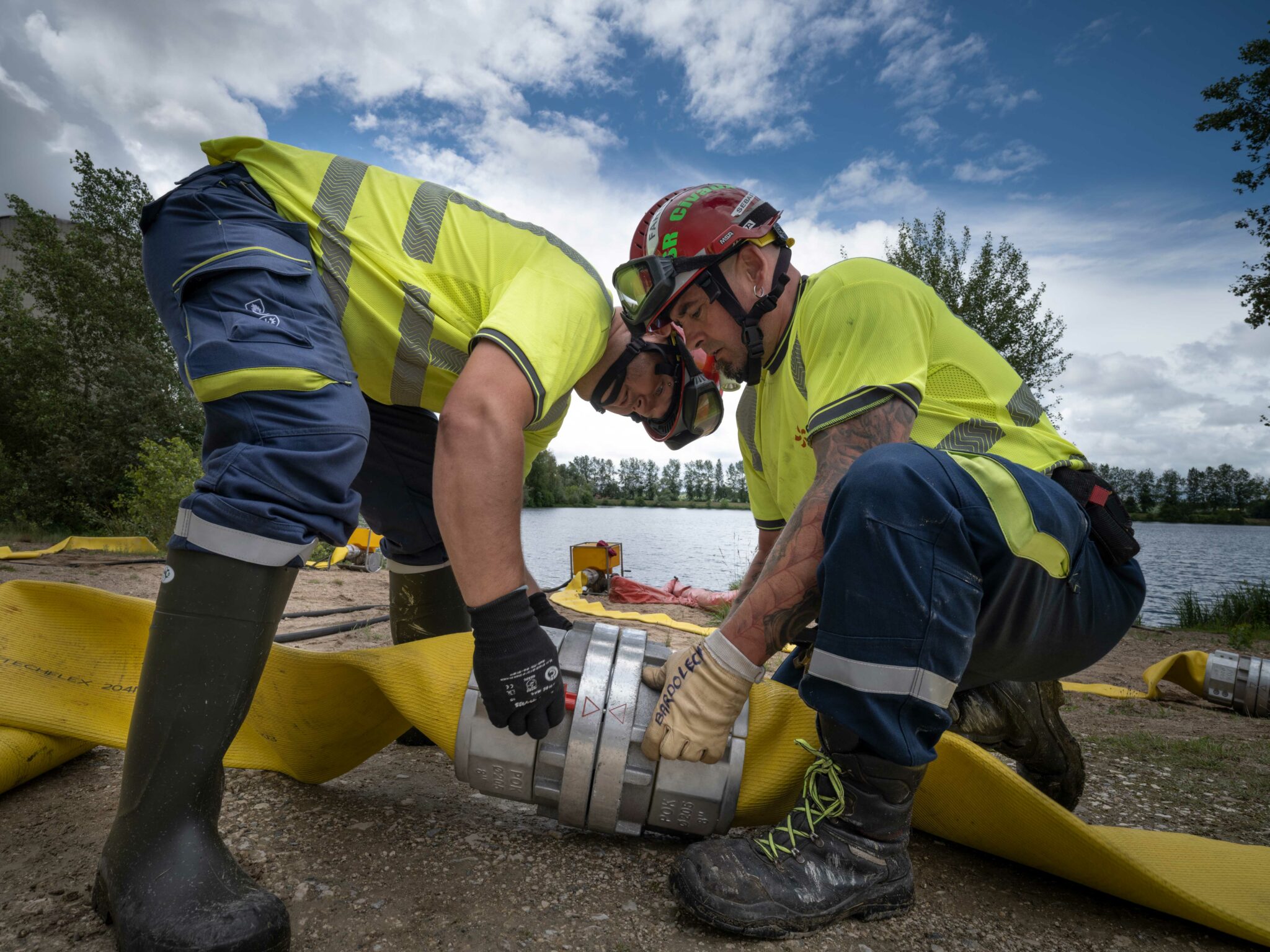 Techniciens en tenue de sécurité installant un équipement sur un site nucléaire